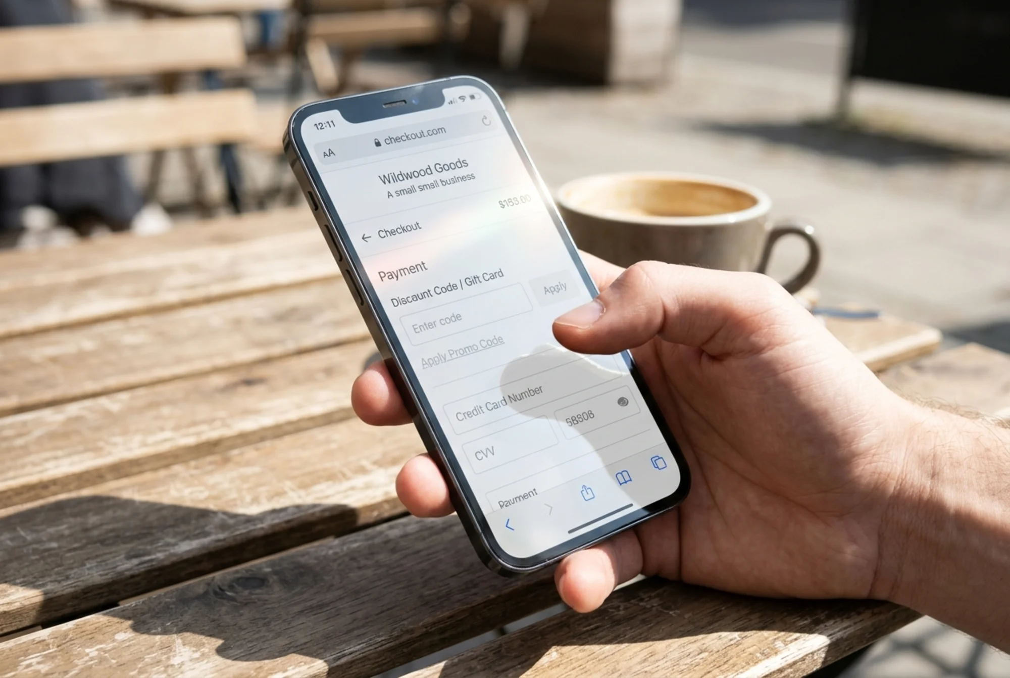 A small business checkout page with light-gray placeholder text inside form fields and a barely-visible "Apply Promo Code" link, viewed in bright outdoor sunlight on a phone screen with glare partially washing out the text