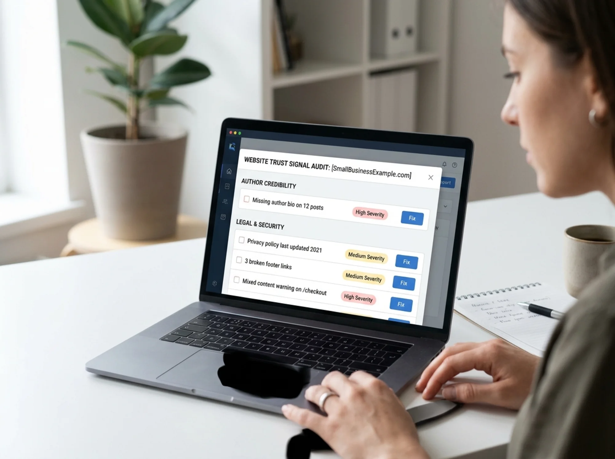 Laptop screen showing a website audit report interface with a categorized checklist of trust signal issues — flagged items include "Missing author bio on 12 posts," "Privacy policy last updated 2021," "3 broken footer links," and "Mixed content warning on /checkout" — each with a severity tag and a Fix button