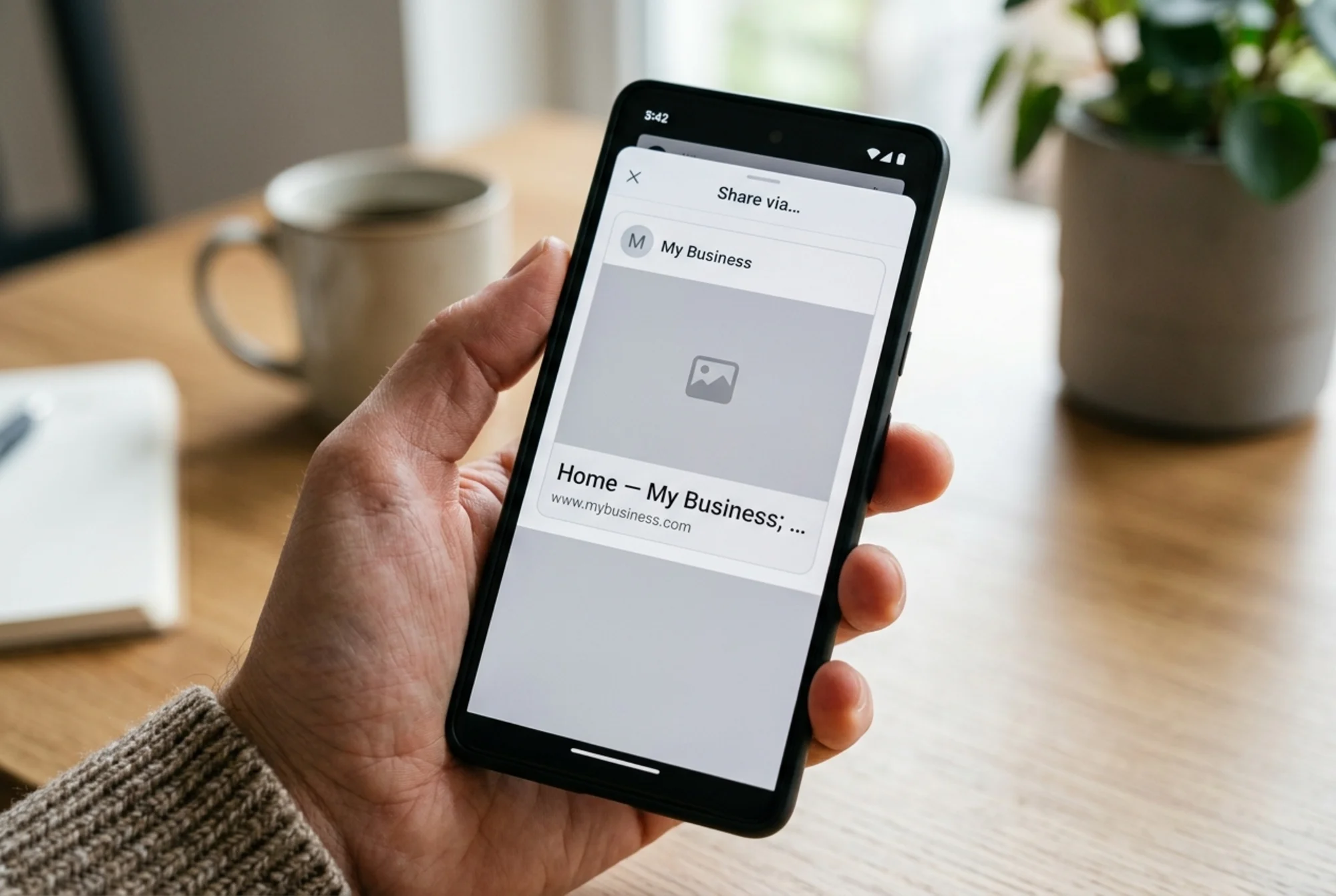 A smartphone screen showing a broken social media share card: blank gray placeholder box where an image should be, a truncated generic title reading "Home — My Business," and a missing description, representing what happens when Open Graph tags are absent