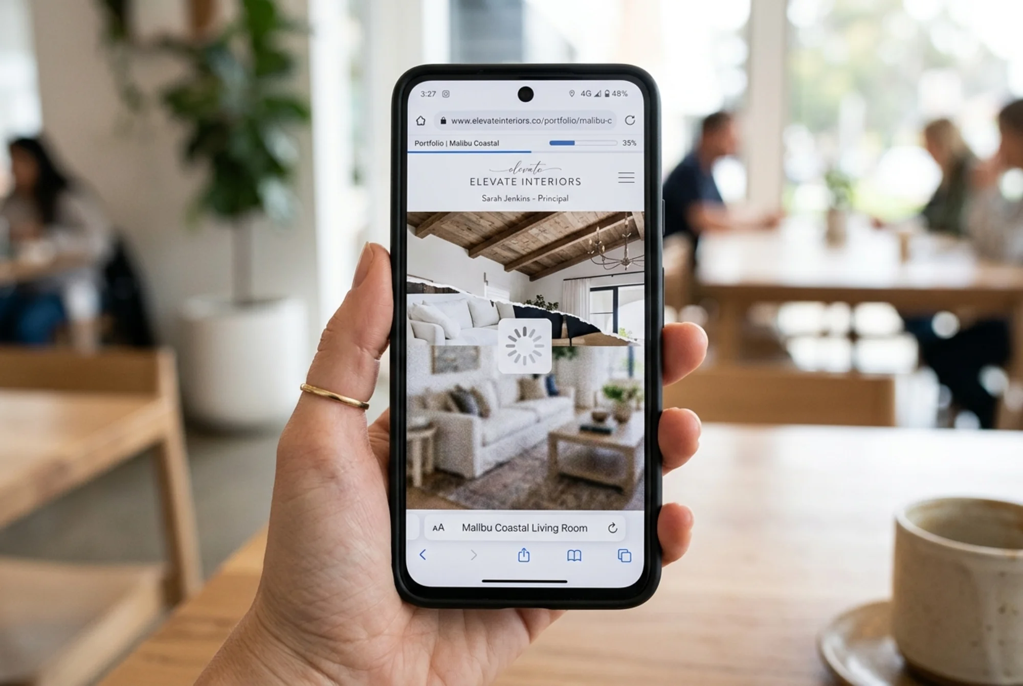 A slow-loading interior design portfolio page on a phone, large unoptimized hero image of a living room half-rendered, mobile loading spinner overlaid, blurry placeholder textures behind it