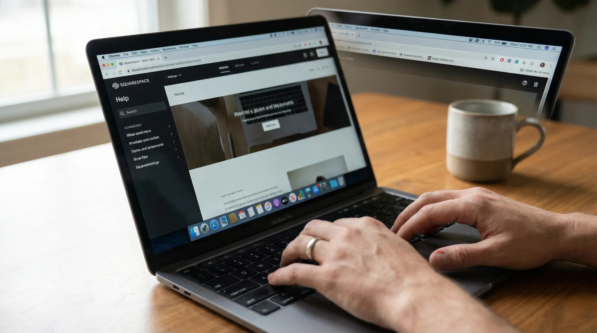 Close-up of hands typing on a laptop with a modern website editor open